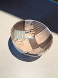 Ceramic bowl with segmented marbled and striped forms