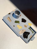 Ceramic candle holder with painted fragmented forms in a soft blue glaze