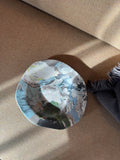 Ceramic plate with contrasting flowing marbled glaze