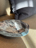 Ceramic plate with dense flowing marbled glaze