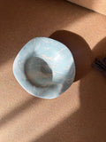 Handmade ceramic plate with flowing marbled glaze