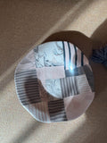 Handmade ceramic plate with layered striped and marbled forms