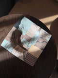 Square ceramic plate with layered marbled and striped forms